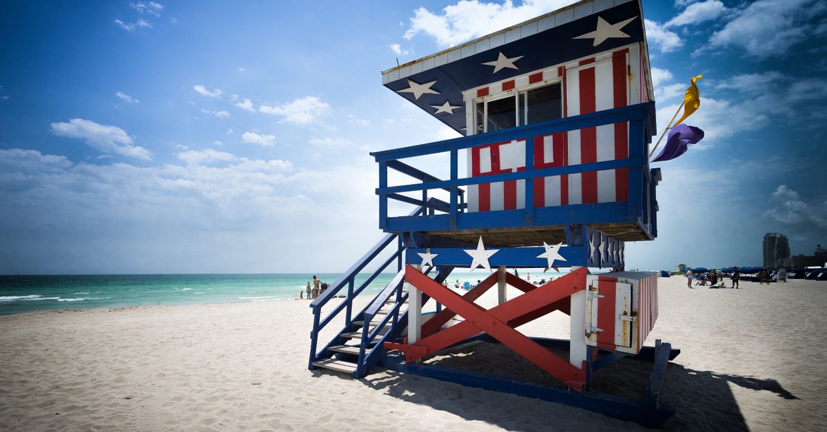 Colorful lifeguard tower with American flag design on Miami Beach.